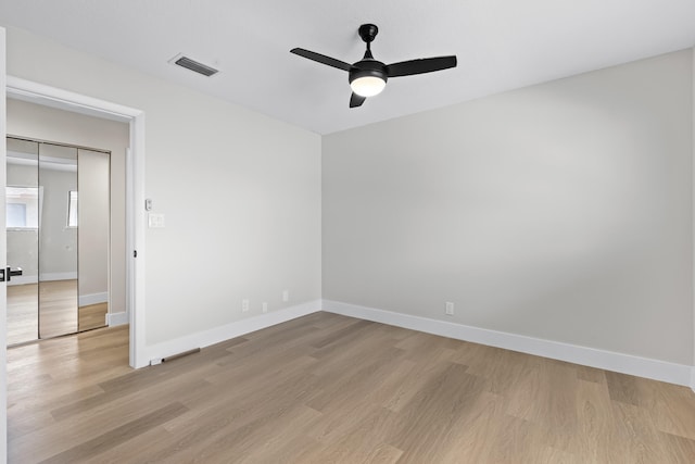 empty room featuring ceiling fan and light wood-type flooring