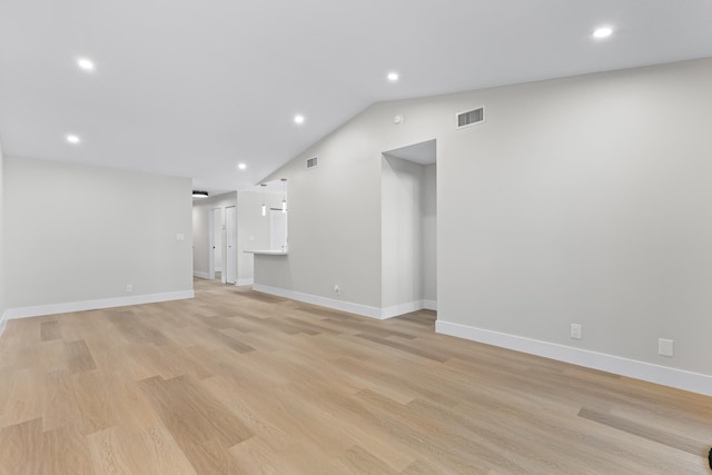 unfurnished living room featuring lofted ceiling and light hardwood / wood-style floors