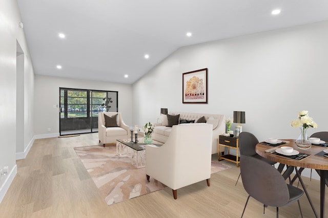 living room with lofted ceiling and light hardwood / wood-style floors