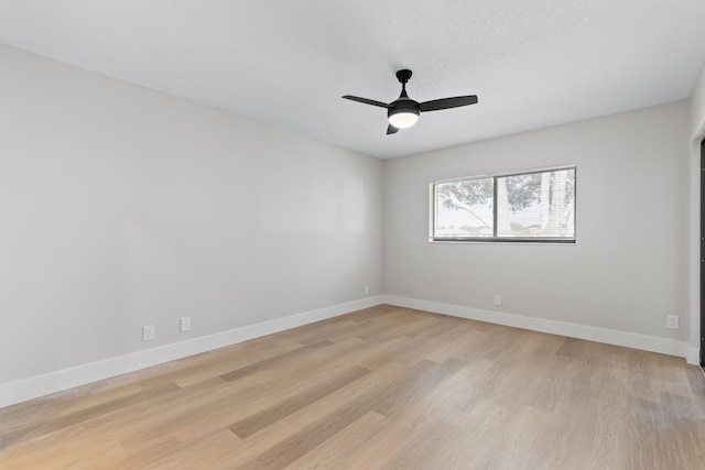 unfurnished room with ceiling fan, a textured ceiling, and light hardwood / wood-style floors