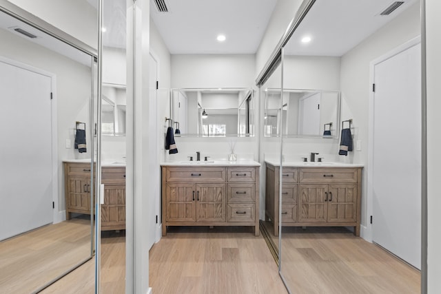 bathroom with hardwood / wood-style flooring and vanity