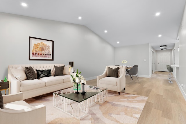 living room with lofted ceiling and light hardwood / wood-style floors