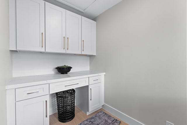 clothes washing area featuring light hardwood / wood-style flooring