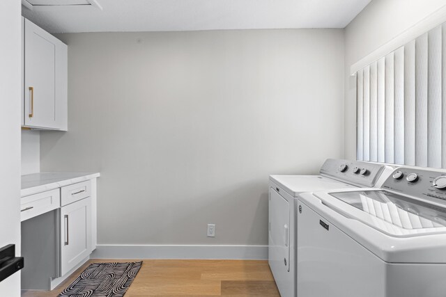 kitchen with white cabinetry, stainless steel appliances, decorative light fixtures, and sink