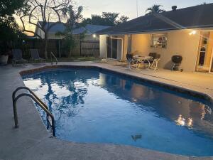 pool at dusk with a patio