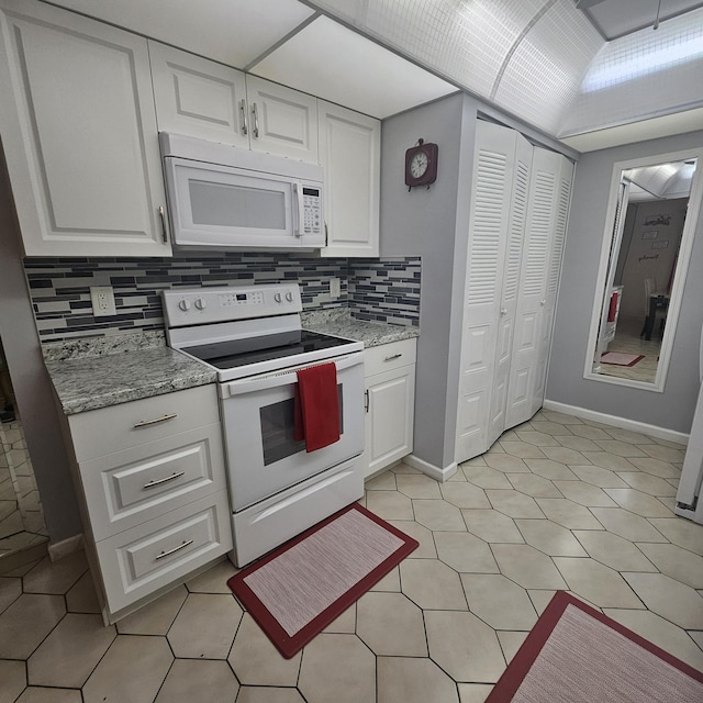 14640 Candy Way, Delray Beach, FL 33484 - kitchen with white appliances, white cabinetry, backsplash, and baseboards