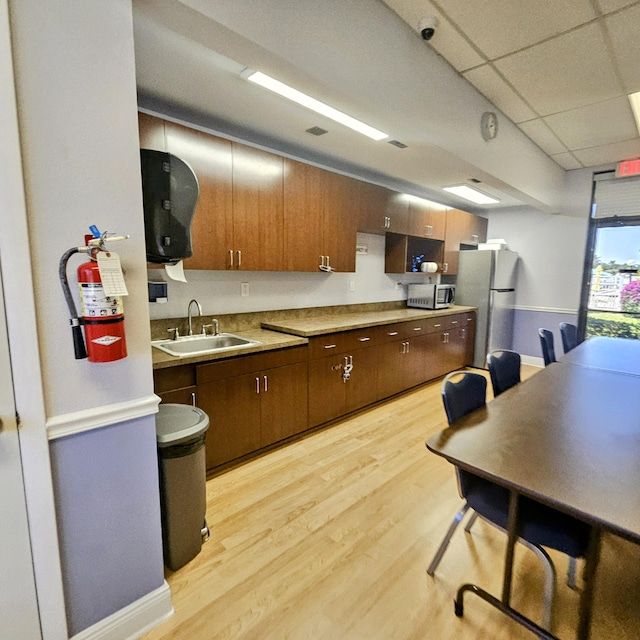 14640 Candy Way, Delray Beach, FL 33484 - kitchen featuring stainless steel appliances, a sink, light wood-style flooring, and light countertops