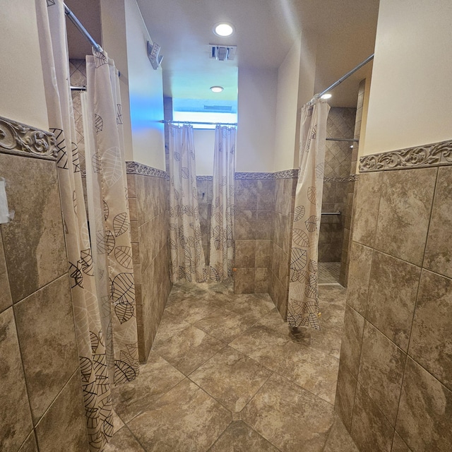 14640 Candy Way, Delray Beach, FL 33484 - bathroom with tile walls, tiled shower, a wainscoted wall, and recessed lighting