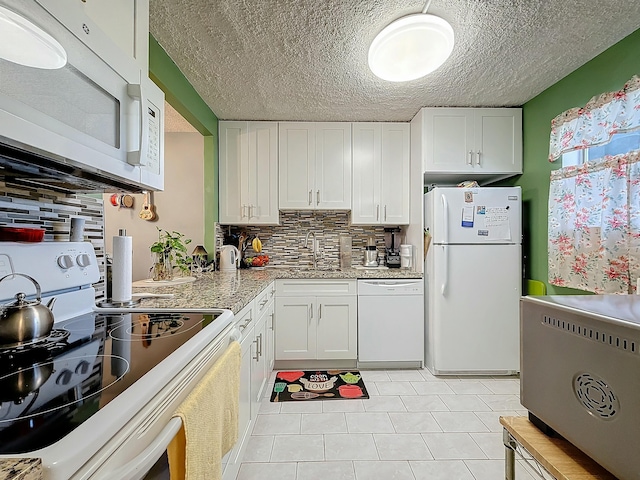 kitchen with white cabinetry, sink, white appliances, and tasteful backsplash