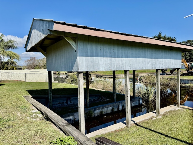 view of dock featuring a yard and a water view