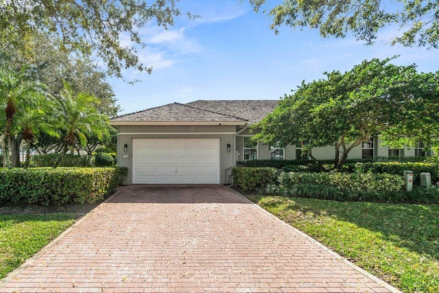 view of front of property featuring a garage and a front lawn