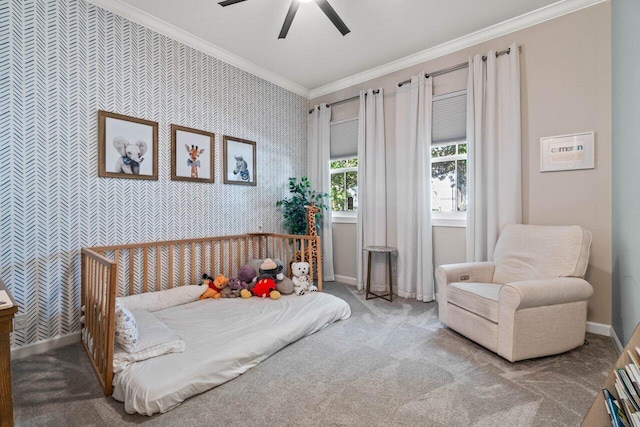 carpeted bedroom with ornamental molding and ceiling fan