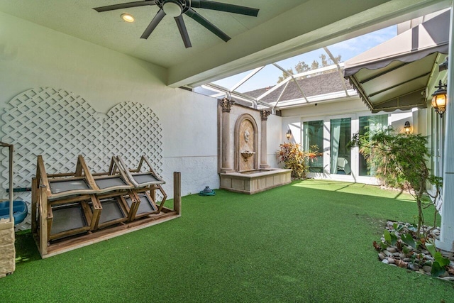 view of yard featuring french doors and ceiling fan