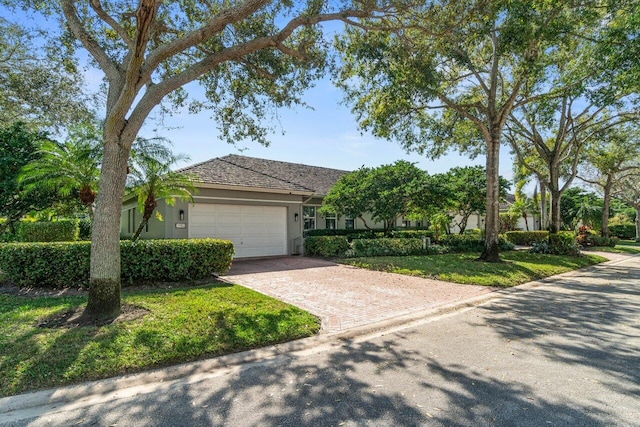 view of front facade with a garage and a front lawn