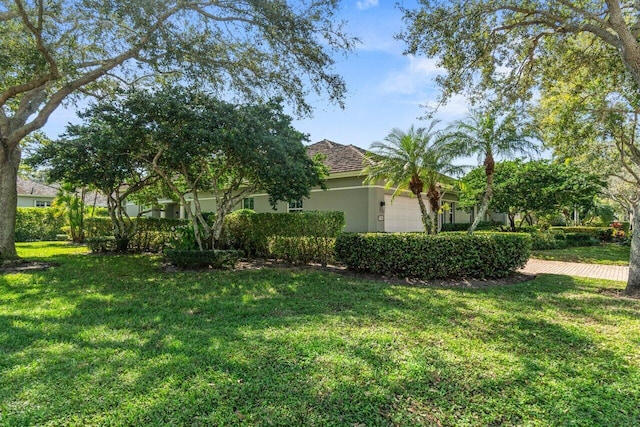 view of front of house with a garage and a front yard