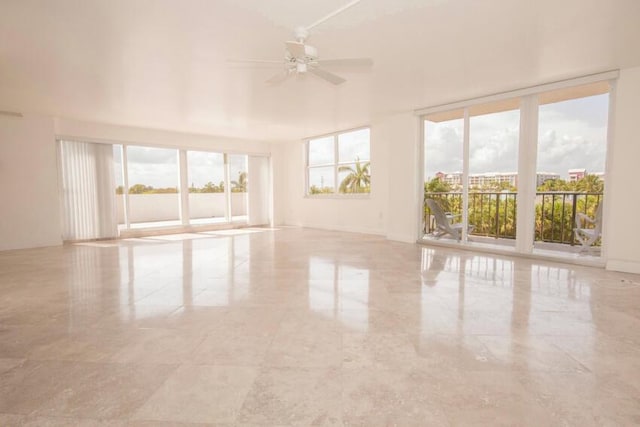 spare room with a wealth of natural light and ceiling fan