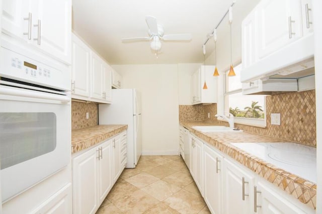 kitchen with sink, white cabinetry, ceiling fan, white appliances, and decorative backsplash