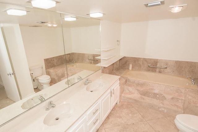 bathroom featuring tile patterned flooring, vanity, tiled bath, and toilet