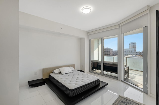 bedroom featuring access to exterior and light tile patterned floors