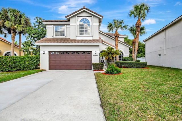 mediterranean / spanish house with a garage and a front yard