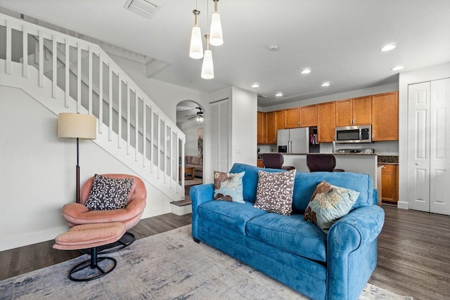 living room featuring ceiling fan and hardwood / wood-style floors