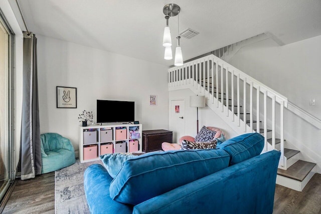 living room with dark hardwood / wood-style floors and a textured ceiling