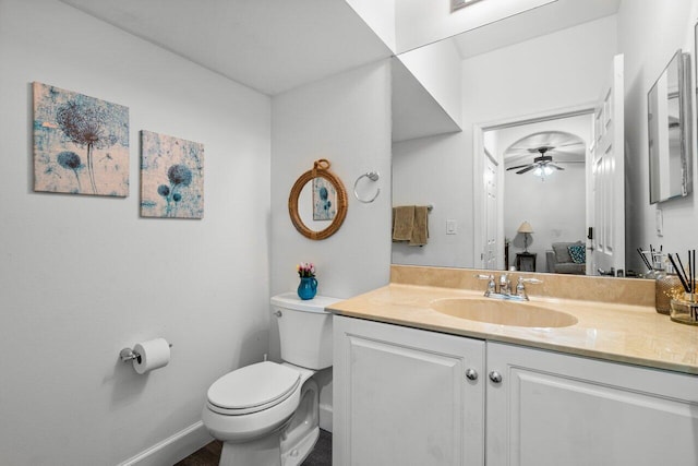 bathroom featuring ceiling fan, vanity, and toilet