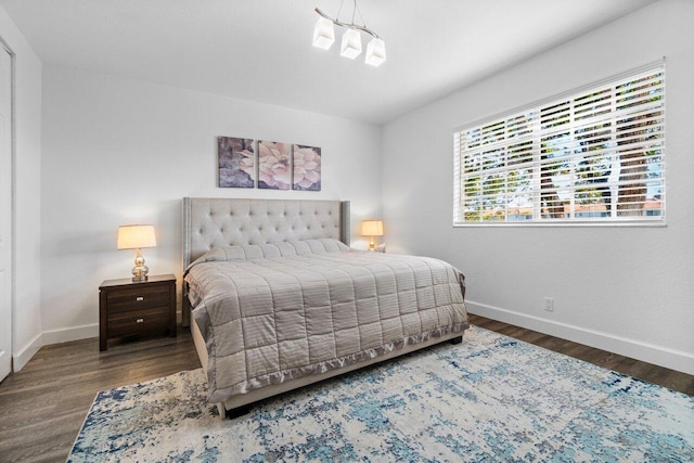 bedroom with a chandelier and hardwood / wood-style floors