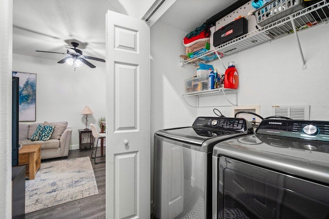 laundry area with dark hardwood / wood-style floors, independent washer and dryer, and ceiling fan