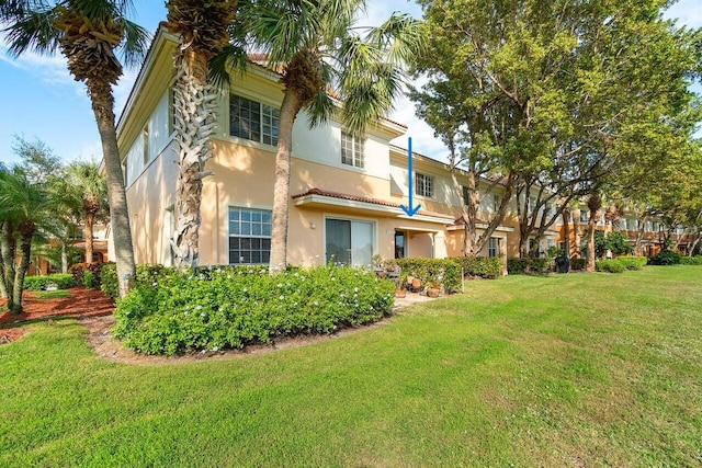 rear view of house featuring a yard