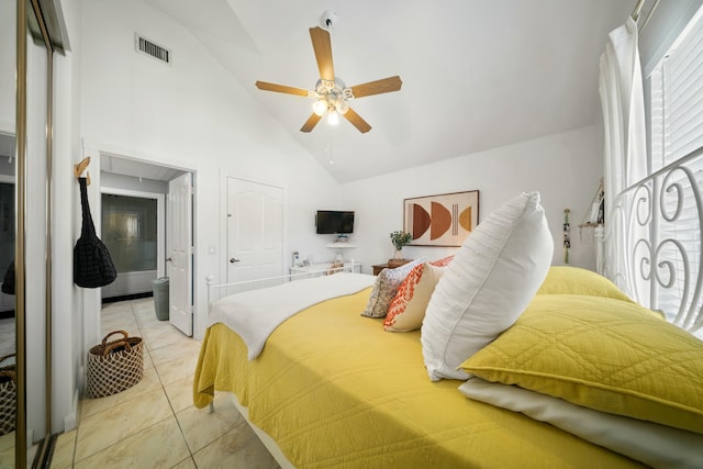 bedroom with ensuite bathroom, high vaulted ceiling, light tile patterned floors, and ceiling fan