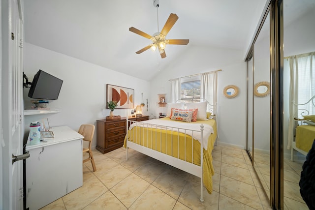 bedroom featuring ceiling fan, lofted ceiling, and light tile patterned floors