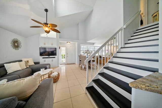 tiled living room featuring high vaulted ceiling and ceiling fan