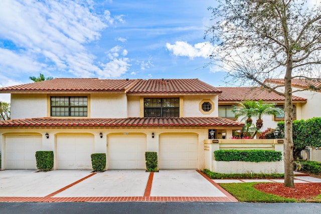 mediterranean / spanish house with a garage