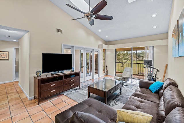 living room featuring french doors, light tile patterned flooring, high vaulted ceiling, a textured ceiling, and ceiling fan