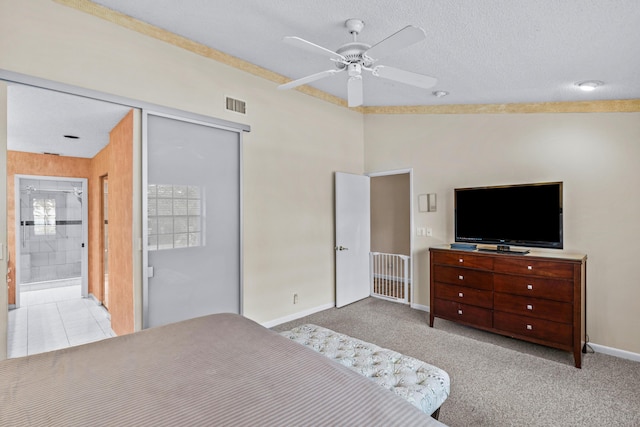 carpeted bedroom featuring a textured ceiling and a closet