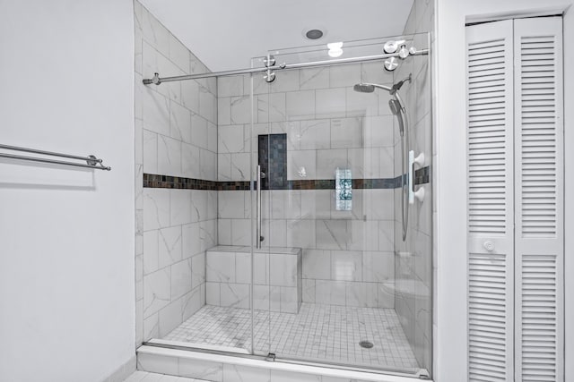 bathroom featuring a shower with door