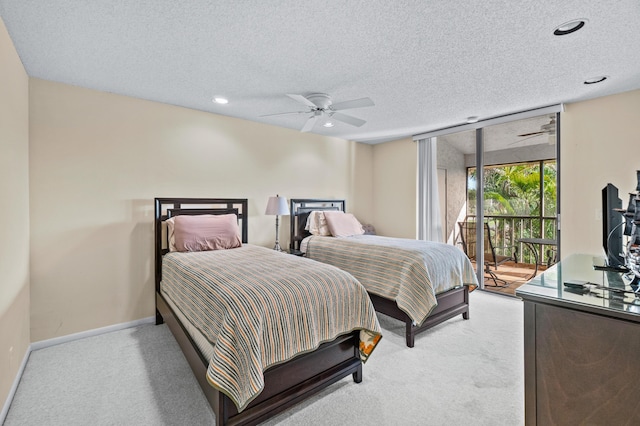 carpeted bedroom with expansive windows, ceiling fan, a textured ceiling, and access to outside