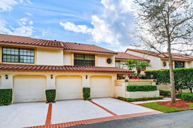 mediterranean / spanish-style house with a garage