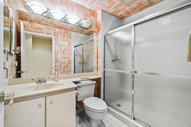 bathroom with vanity, a shower with shower door, and tile patterned floors