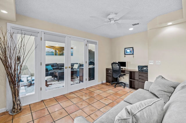 tiled office featuring french doors, ceiling fan, and a textured ceiling