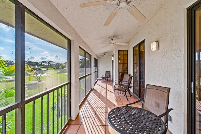 sunroom / solarium featuring lofted ceiling and ceiling fan