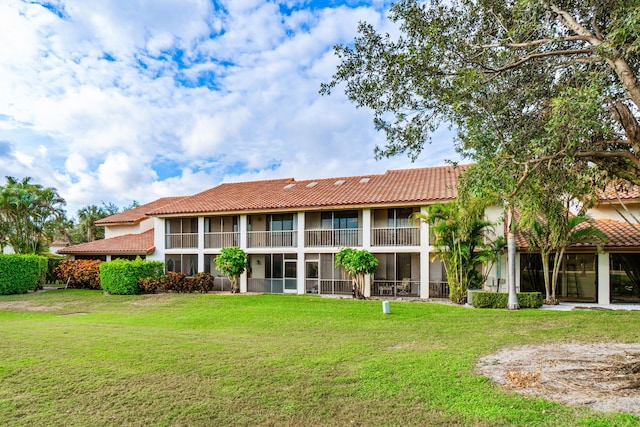 rear view of property with a lawn