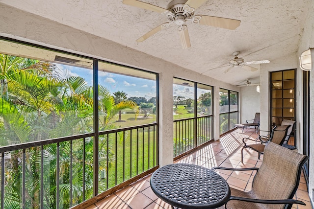 sunroom featuring a wall mounted air conditioner, vaulted ceiling, and ceiling fan