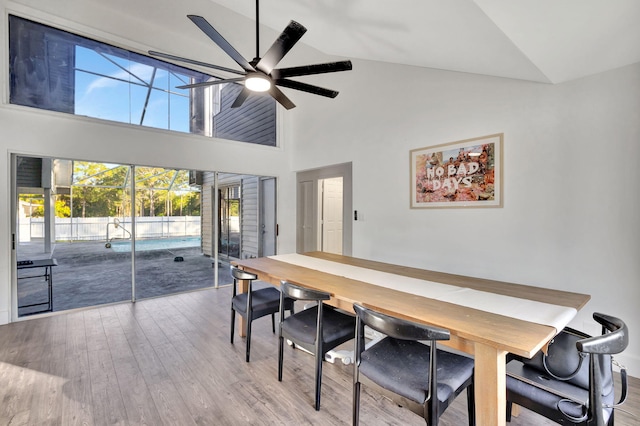 dining space with lofted ceiling, ceiling fan, and light wood-type flooring