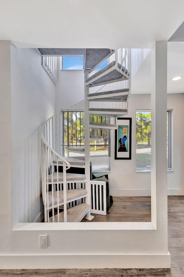 stairs with hardwood / wood-style floors