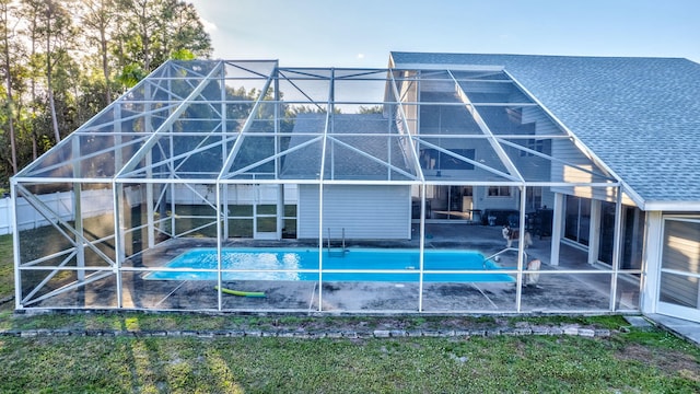 rear view of property with a patio area and glass enclosure