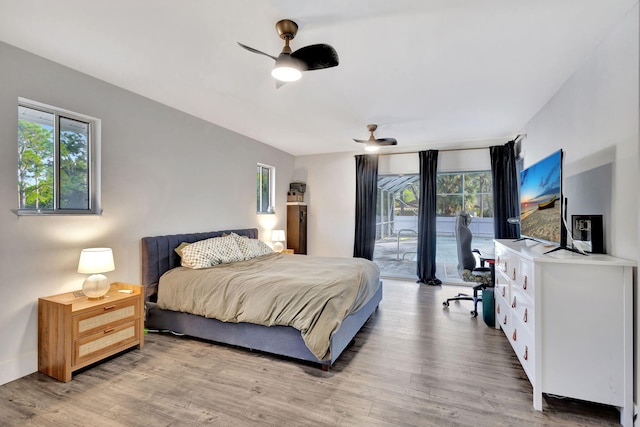 bedroom featuring hardwood / wood-style flooring, access to exterior, and ceiling fan