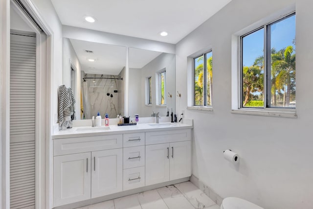 bathroom with vanity and tiled shower