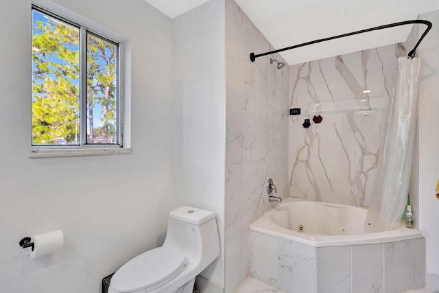 bathroom featuring shower / tub combo and toilet